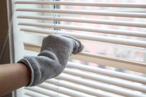 02 Clean your blinds with vinegar and old sock
