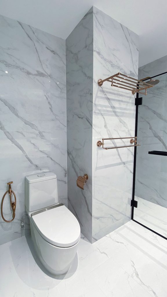 Grey and White Marble Condo Bathroom with Gold Accents