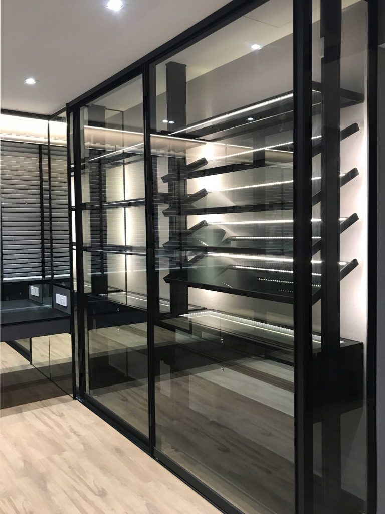 condo walk in closet in dark industrial theme with shoe and bag rack