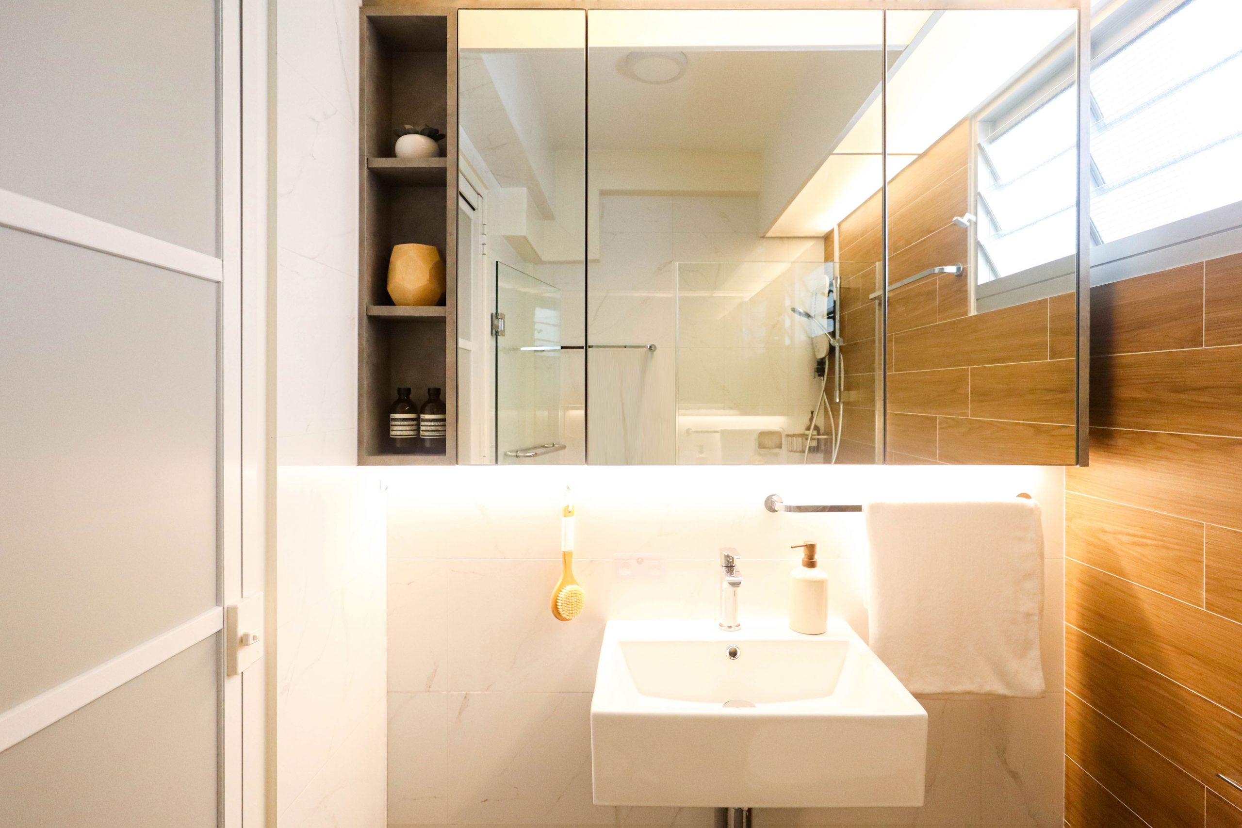 muji style HDB bathroom with vanity mirror shelf