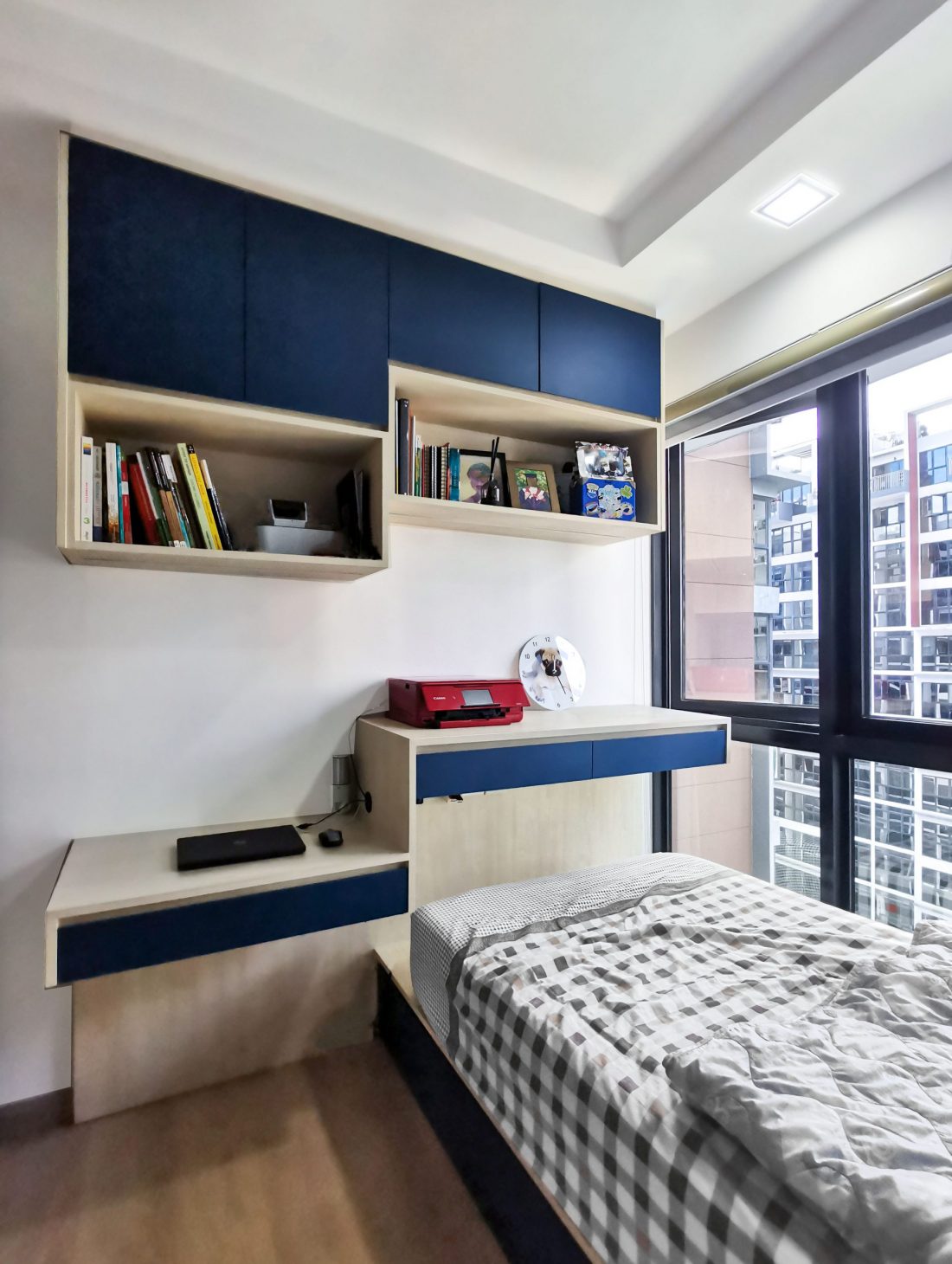 Condo bedroom custom study desk and book shelves in blue laminate